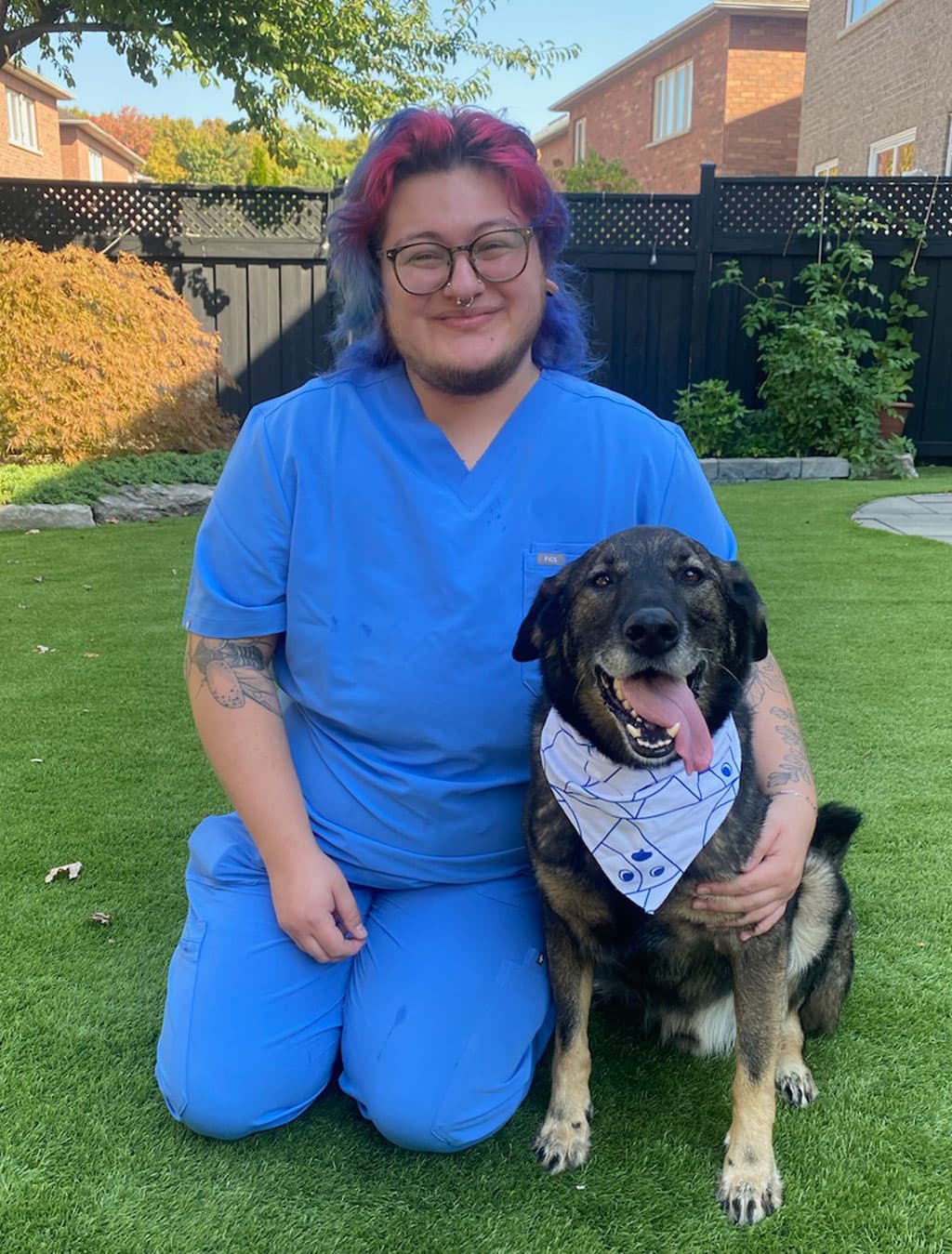 Charlie, Customer Service Representative and his pet dog Oso at Upper Village Veterinary Hospital in Toronto, ON