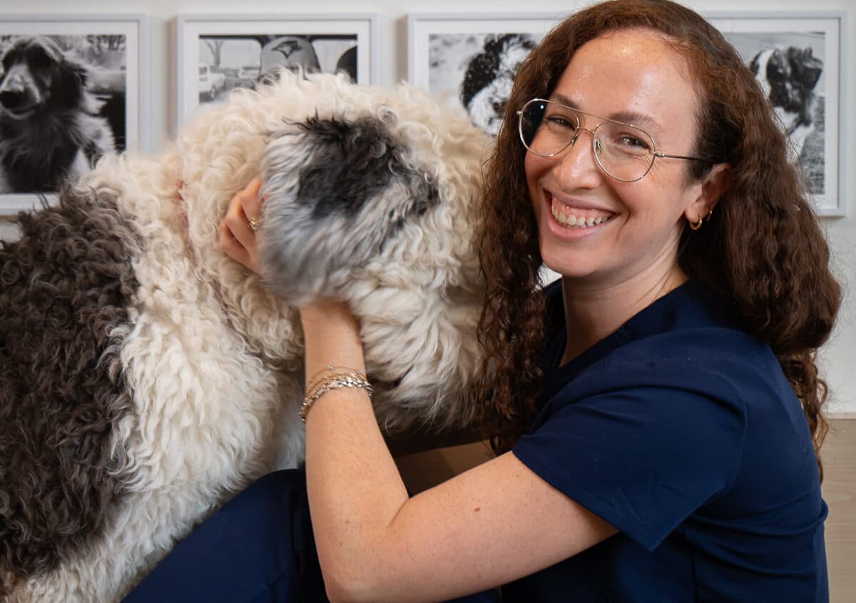 Smiling person hugging fluffy dog, symbolizing healthy weight management tips for pets in Toronto, ON